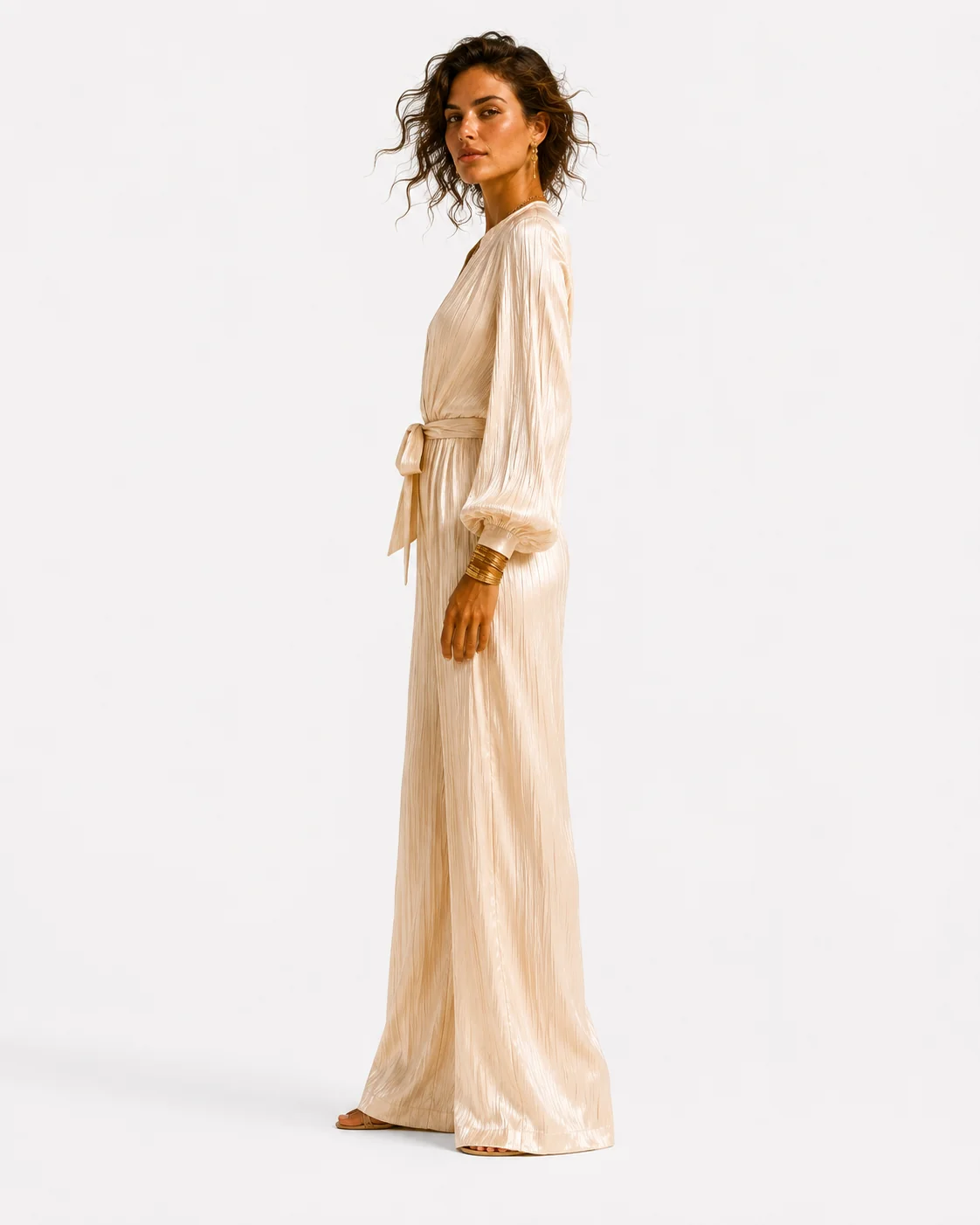 Side studio view of cream pleated silk jumpsuit.