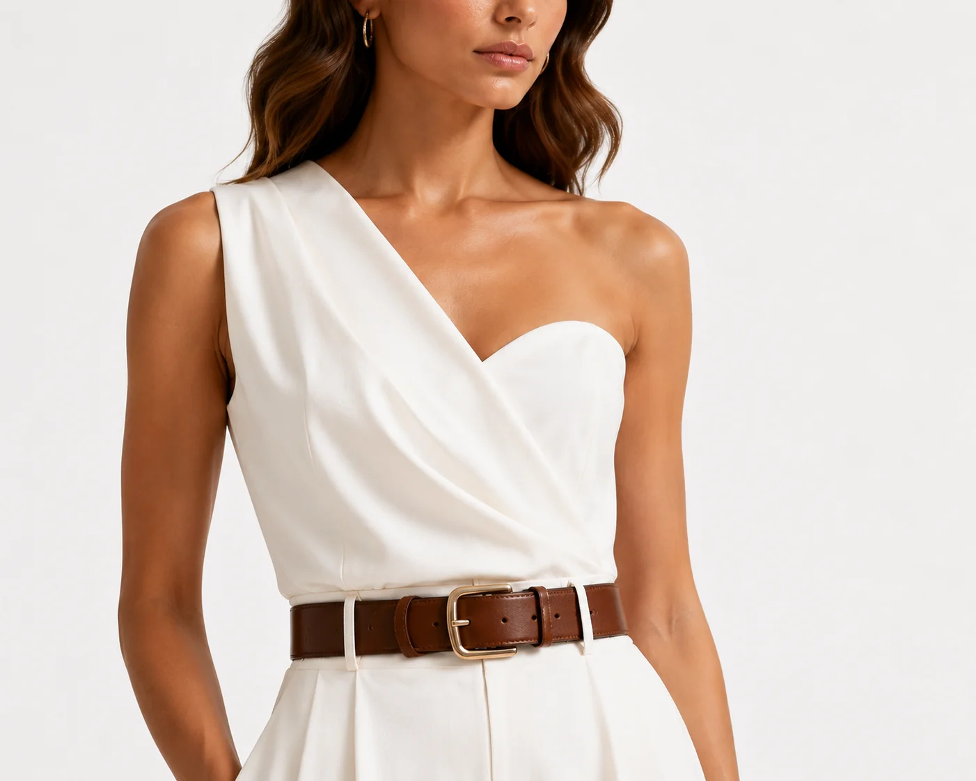 Close-up detail image of the bodice and belt on a white one-shoulder jumpsuit.