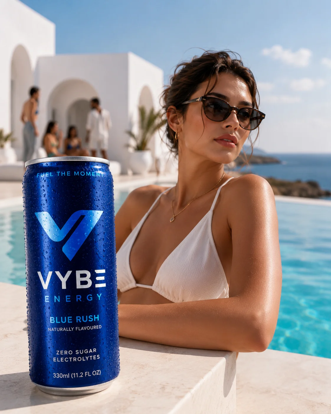 Vybe Energy lifestyle image with the can placed poolside beside a model in a white resort setting.